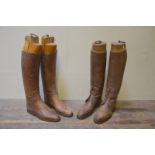 Two pairs of vintage tan leather gentleman's boots both with sectional boot trees with brass pulls