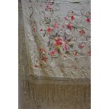 An apricot silk shawl, 124 cm x 130 cm, an embroidered cream silk crepe stole with fringing,