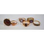 A collection of six 9ct stone set rings including oval garnet cluster, garnet five stone,