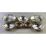 A pair of Edwardian silver embossed open salts on ball feet, Birmingham 1901,