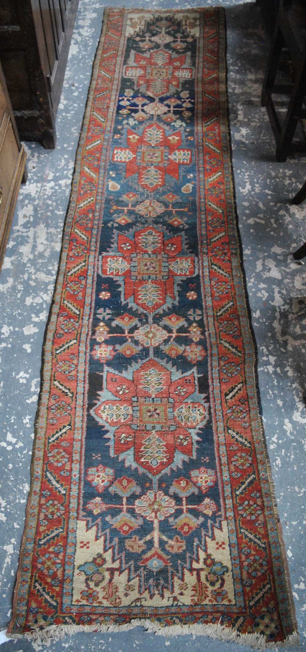 A Persian Heriz carpet, the large central blue medallion on red ground with stylised floral design, - Image 7 of 7
