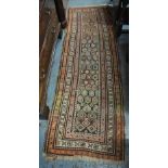 An antique Kurdish runner, the centre panel of repeating multicoloured botehs on brown/blue ground,