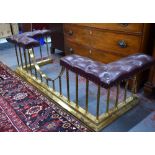 A Victorian style brass rail club fender having buttoned red leather corner seats,