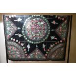 An early 1900s black velvet panel embroidered in silks with floral roundel to centre and birds and