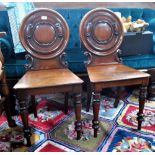 A pair of Victorian mahogany hall chairs,