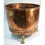 A large 19th century hammered copper log bin on cast brass feet,