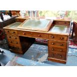 A late Victorian mahogany part-slope top pedestal desk having a centre hinged slope over an