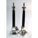 A pair of silver plated and black granite Corinthian column table lamps,