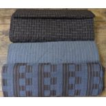 Six bolts of wool/mix fabric in grey and brown patterned designs,