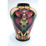 A Moorcroft trial vase decorated with stylised flowers, possibly orchids or hibiscus,