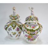A pair of Dresden oviform vases; each one with domed cover and kneeling cherub finial,