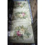 A small Aubusson style wool rug with pale green ground with two floral design lozenges,