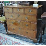 A William and Mary feather-banded walnut chest of three short over three long graduated drawers,