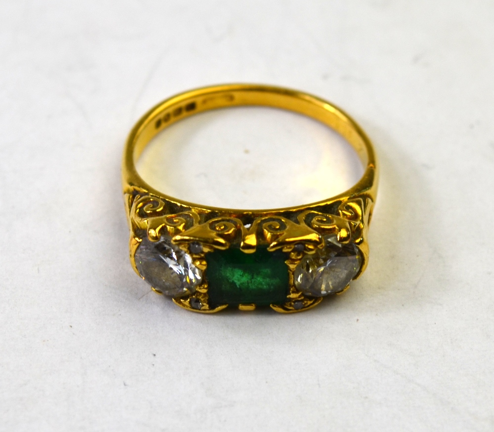 An emerald and diamond three stone ring, 18ct yellow gold carved setting,