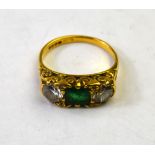 An emerald and diamond three stone ring, 18ct yellow gold carved setting,