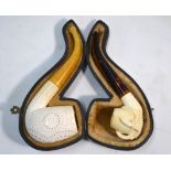 Two modern Meerschaum pipes with amber s