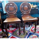 A pair of Victorian mahogany hall chairs