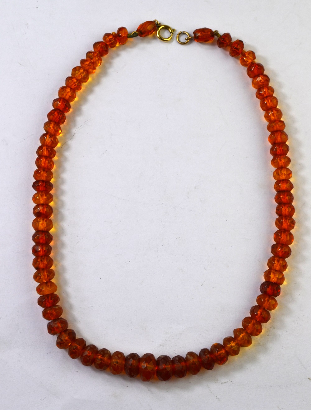 A single row of graduated facetted amber