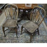 A set of four wheel back Windsor chairs