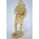 A sectional ivory okimono of a standing crab fisherman,