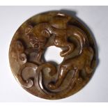 A mottled brown/green jade circular bi,