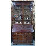 A George III mahogany bureau bookcase, the moulded cornice over astragal glazed cabinet doors,