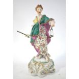 An 18th century Derby figure of Justice standing on a tall rococo scrolled base,