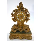 A 19th century French gilt metal mantel clock, cast with flowers, gilt dial with enamel chapters,