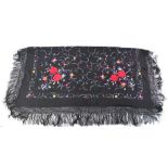 A Chinese silk black ground shawl, decorated with butterflies,