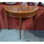 An Edwardian inlaid mahogany demi lune folding card table,