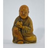 A Chinese soapstone figure of a seated Luohan, holding a bowl with the left hand, 6.