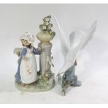 A Lladro figure of a young girl beside a pedestal and stone balcony with urn of flowers, 29 cm high,