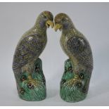 A pair of 'susancai-style' figures of birds-of-prey; each one perched on pierced rockwork,