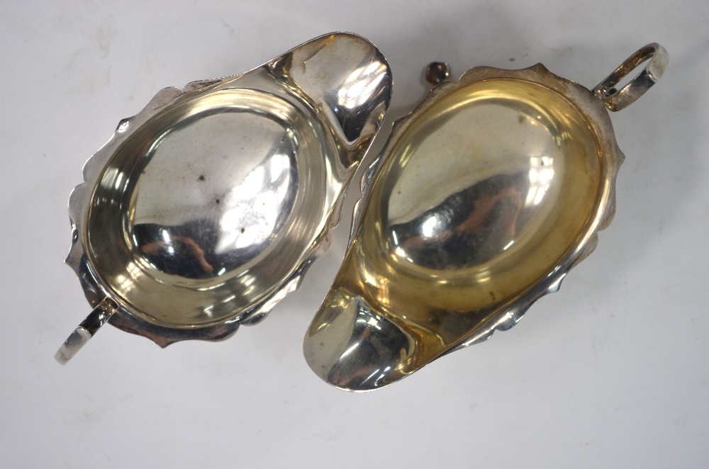 A near-matched pair of silver sauce boats with cut rims, scroll handles and pad feet, - Image 3 of 4