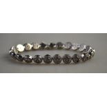A white metal bracelet formed of twenty-three circular clusters set with small diamonds,
