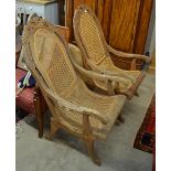 A pair of Indonesian teak plantation chairs with caned seats and back Condition Report