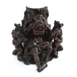 An early 19th century Black Forest (probably) carved wood and brown gesso group of a seated old man