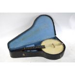 A cased banjolele,