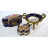 Two Sevres shaped boxes: one decorated with a winged cherub beside a classical beauty,