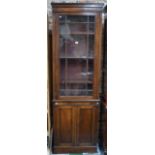 A mid 19th century mahogany library bookcase of narrow form in two parts,