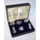 A cased silver six-piece condiment set with blue glass liners, Deakin & Francis,
