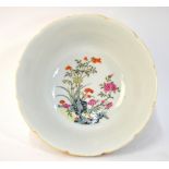 A famille rose bowl, decorated with a design of butterflies or other invertebrates; 17cm diameter,