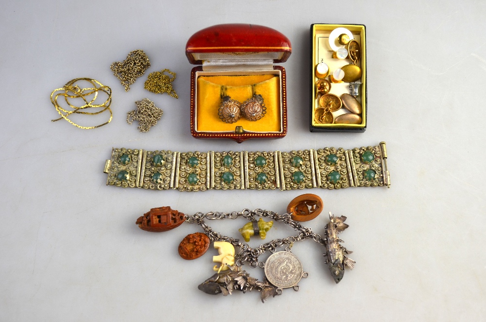 Lot containing various jewellery items including charm bracelet with carved charms and articulated