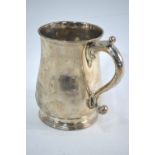 A George III Irish silver plain baluster half-pint mug with scroll handle and moulded foot-rim,