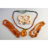 Lot containing row of freshwater pearls, amber necklace, imitation amber pendant containing insect,