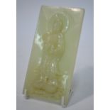 A green jade plaque of whitish hue, carved in high relief with a figure of a Bodhisattva,