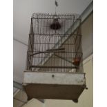 An antique tinplate and wire birdcage