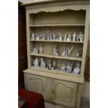 A part 18th century French open dresser/bookcase with twin cupboards to the base,
