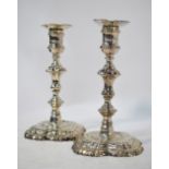 A pair of George II cast silver baluster candlesticks on square scalloped bases, John Calfe,