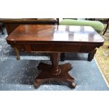 A Regency rosewood fold over card table raised on a tapering octagonal support to an inverted